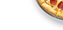 A red plate stacked with slices of garlic cheesy bread.