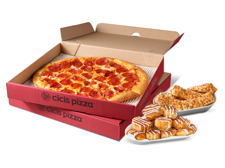 Stacked Cicis pizza boxes with one open showing a pepperoni pizza. Next to the boxes are a plate of cinnamon rolls and a plate of garlic cheesy bread.